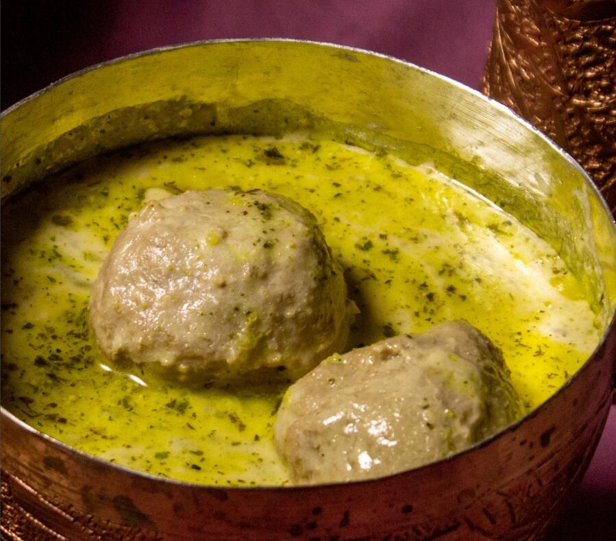 Gushtaba: hand-pounded lamb meatballs in a curd-and-mint yakhni, served in an engraved copper bowl